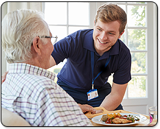 Care Provider Bringing Meal to Elderly Patient